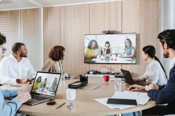 Barco Clickshare conferencing System and a group of people have a hyprid meeting 